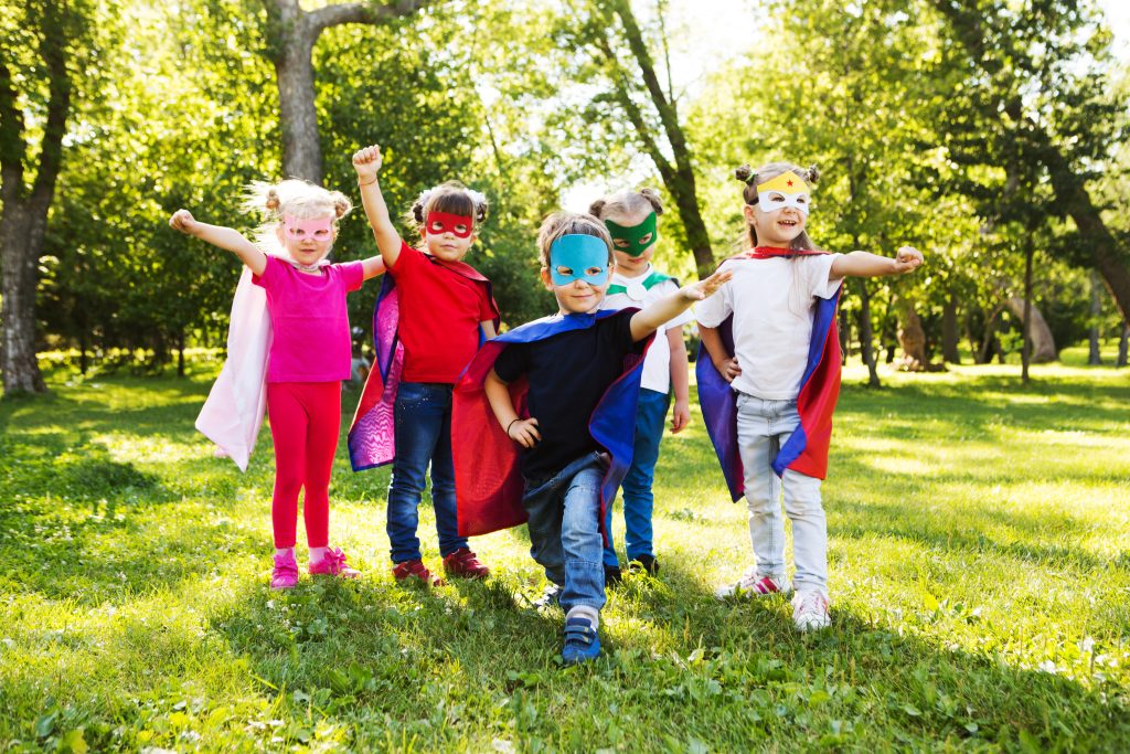 group kids friends superhero playing togetherness and having fun outdoor..