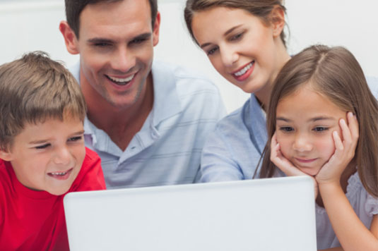 Family sitting around laptop